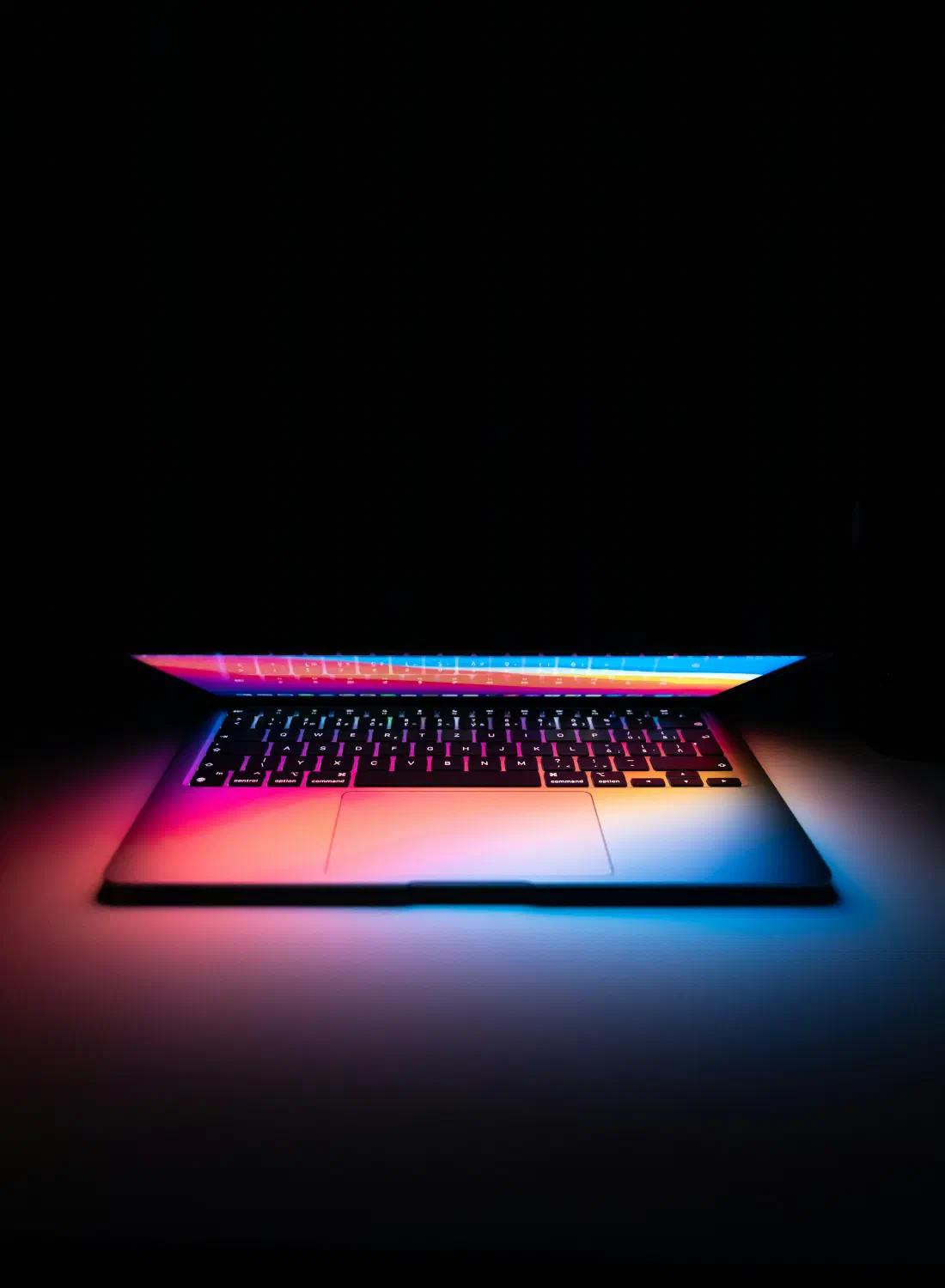 A laptop glowing in a dark room — where first impressions of your business are made