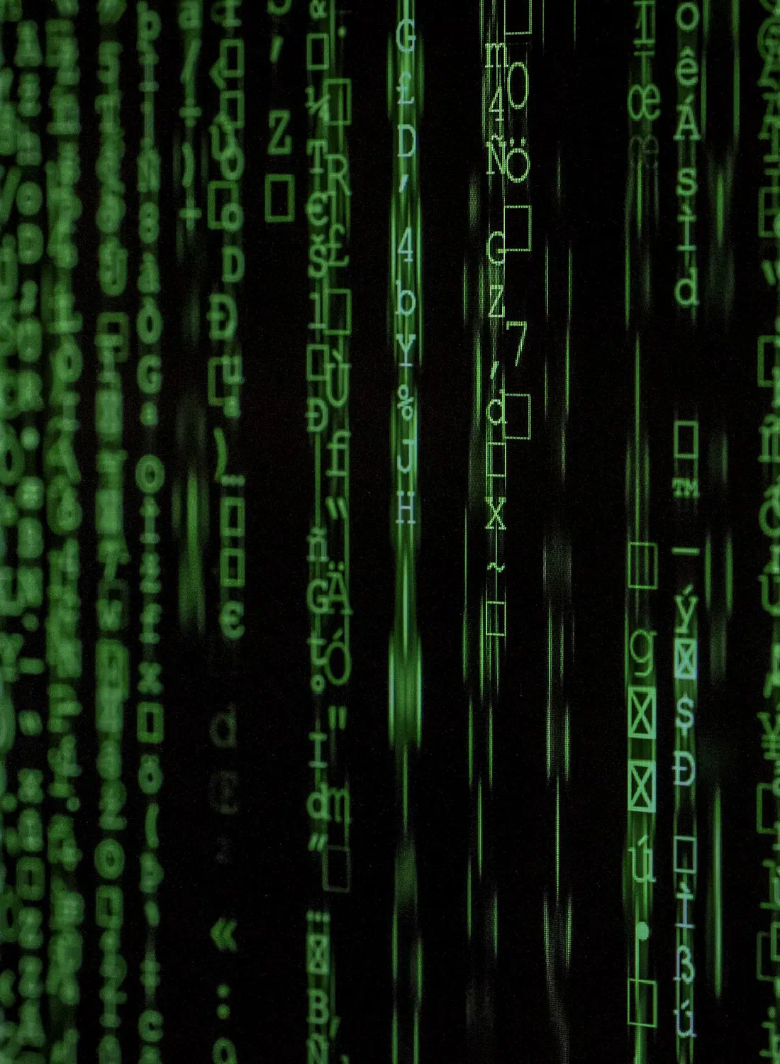 Green cascading data code on a dark screen — where your data lives, and under whose laws